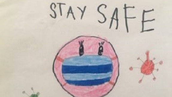 A drawing of a pink face with a blue mask on it, surrounded on either side by a coronavirus. Above it, the words "STAY SAFE."