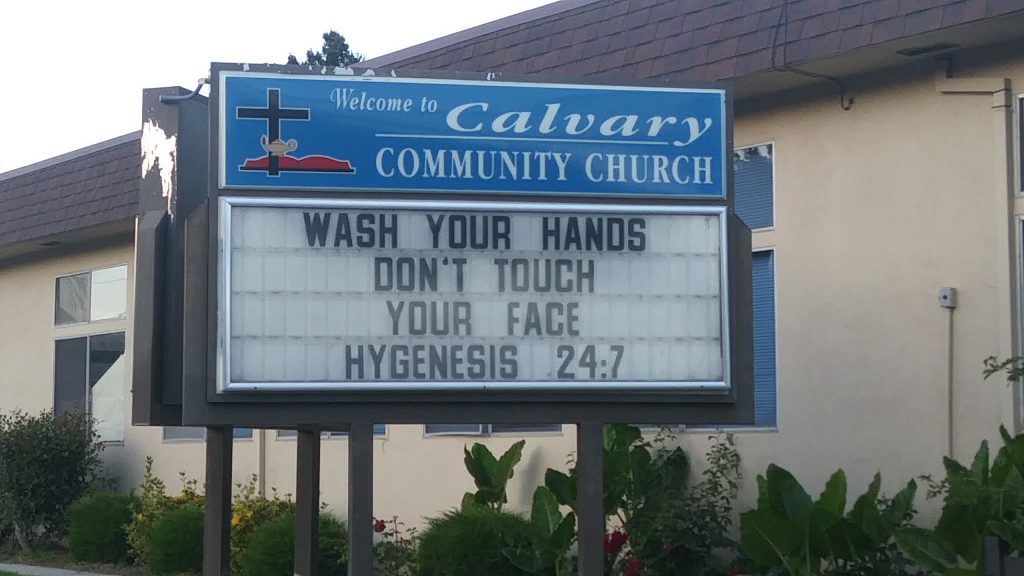 A blue sign in front of Calvary Community Church.