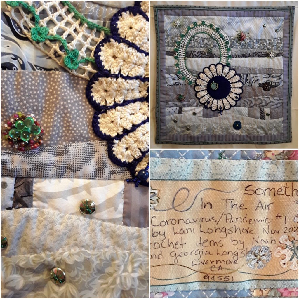 A grey patterned quilt with a large crocheted flower and other decorative elements.